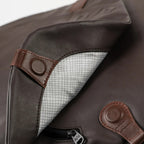 Lieblingstasche Matsumoto dark brown bag with brown leather accents and a grey grid-patterned interior lining