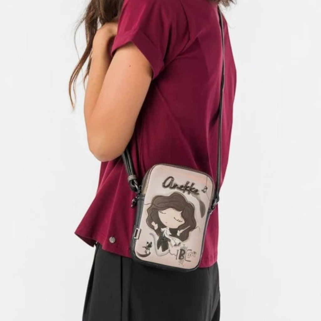Lieblingstasche mini cross-body bag with Anekke character illustration worn by a woman in a burgundy top