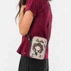 Lieblingstasche mini cross-body bag with Anekke character illustration worn by a woman in a burgundy top