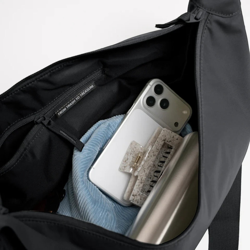 Lieblingstasche GOT BAG Moon Bag Large in black showing the spacious interior with a zippered pocket and accessories