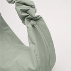 Lieblingstasche Moon Bag Ruffle Large in sage green made from recycled fishing nets with a gathered strap detail.