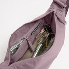 Lieblingstasche Moon Bag Small in dusty purple with open zipper showing internal pocket and personal items
