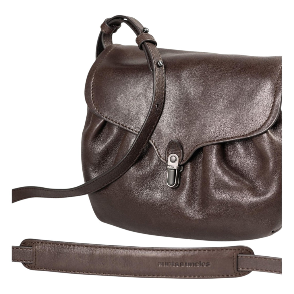 Lieblingstasche Mrs. Coconut Cake dark brown leather crossbody bag with a flap closure and adjustable shoulder strap.