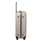 Lieblingstasche OVERSEAS 4w Trolley L in beige with a hard shell, vertical ridges, and black telescopic handle.
