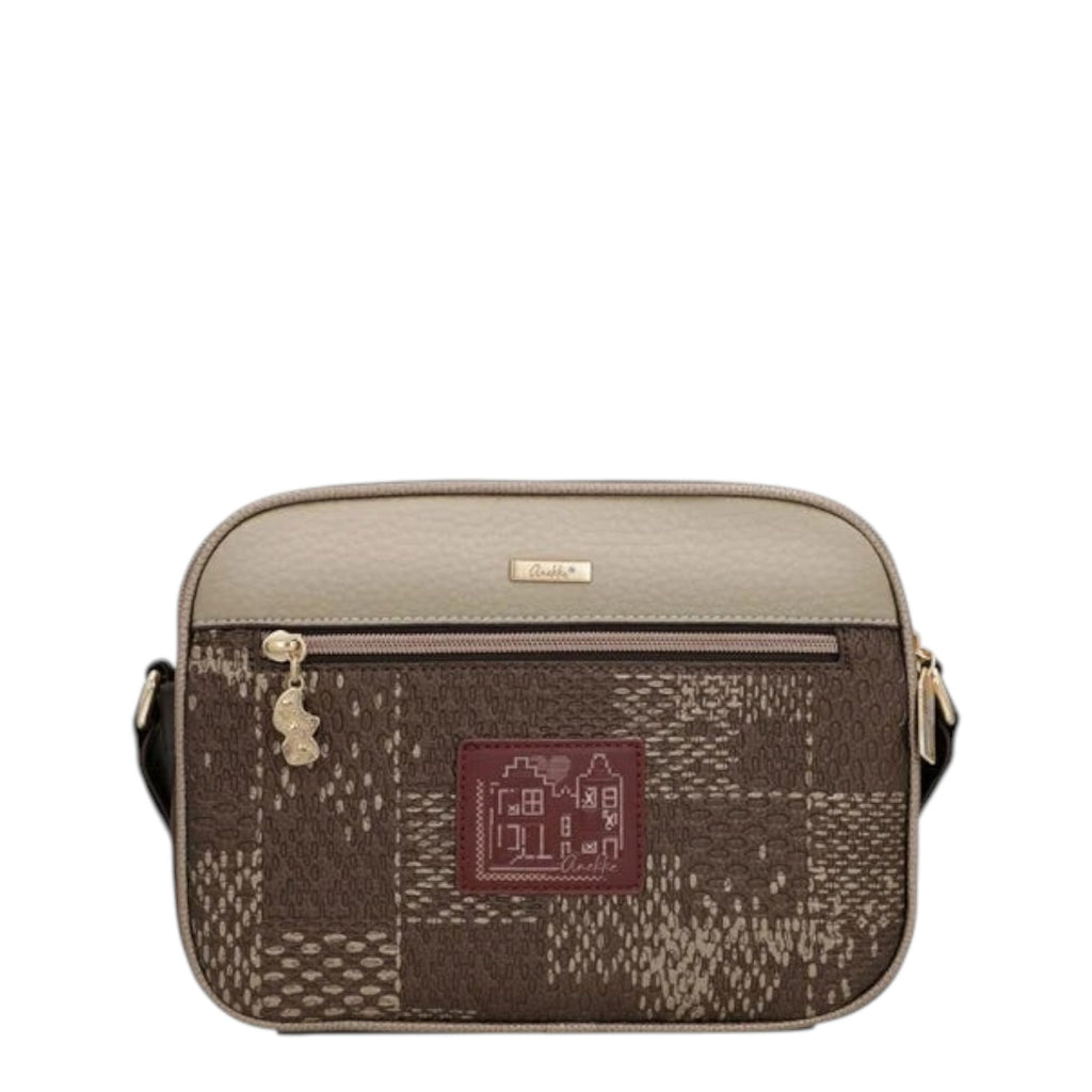 Lieblingstasche cross-body bag in beige and brown with a patterned patchwork design and a small house logo patch.