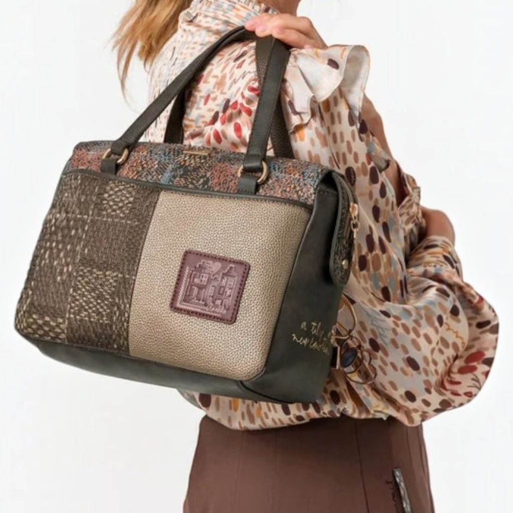 Lieblingstasche short handle bag featuring a multi-textured brown and metallic patchwork design carried on shoulder
