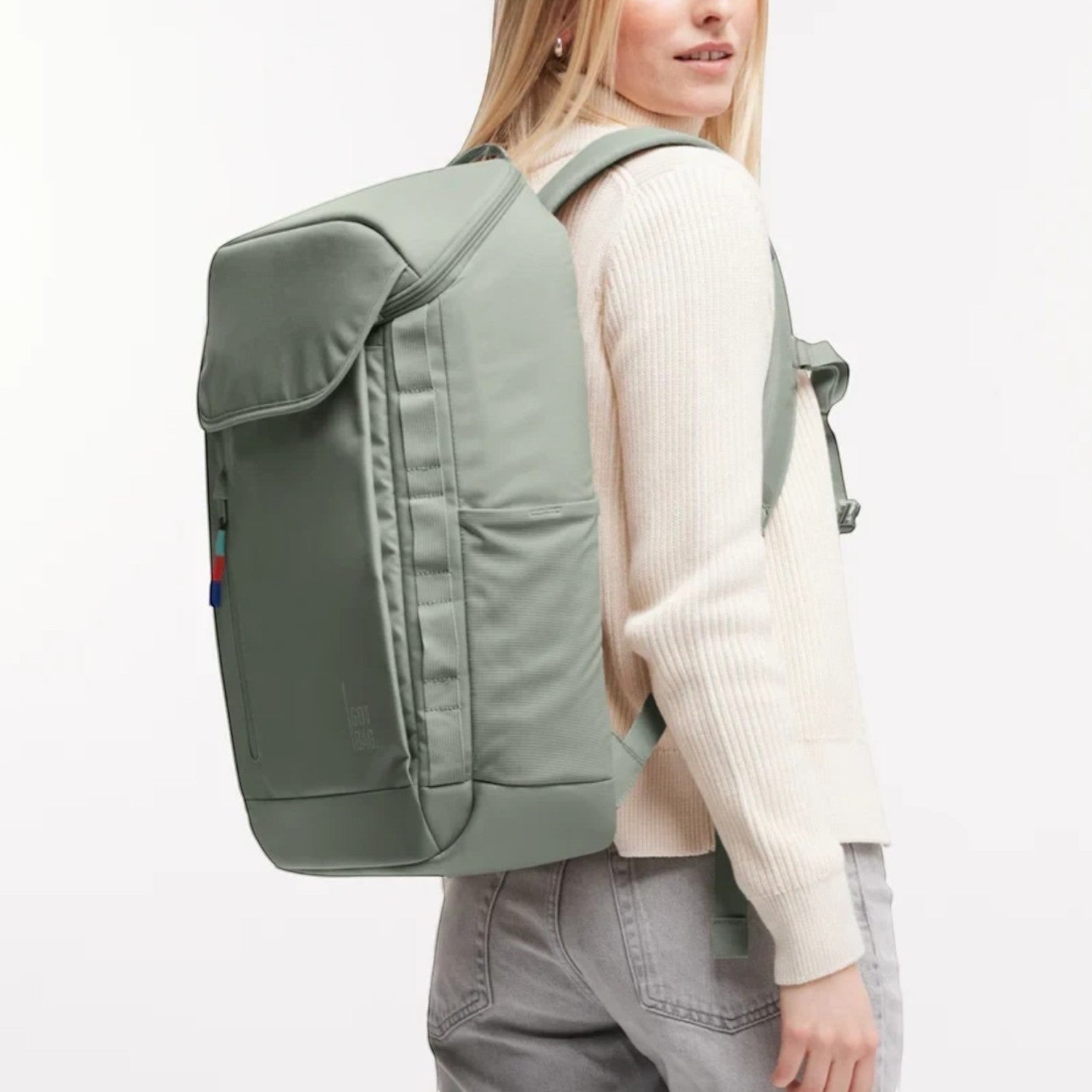 Lieblingstasche Pro Pack sage green laptop backpack worn by a woman, featuring ergonomic straps and side pockets.