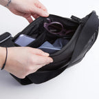 Lieblingstasche Puffer Moon Bag Small in black with interior compartments showing organized personal items