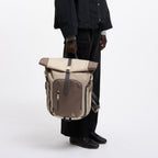 Lieblingstasche Rolltop Adventure backpack in beige and brown canvas with multiple pockets and adjustable straps.