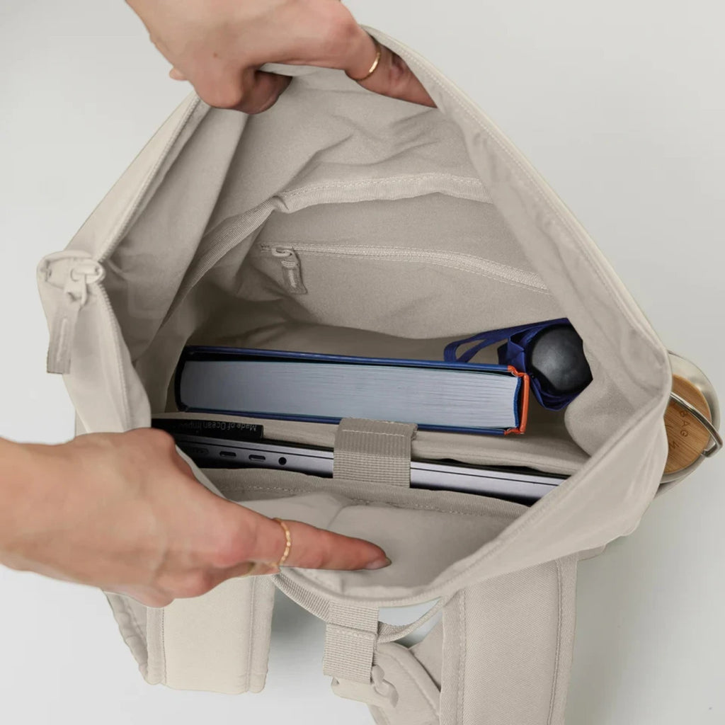 Lieblingstasche Rolltop Easy Small backpack interior view showing laptop compartment, book, and water bottle storage.