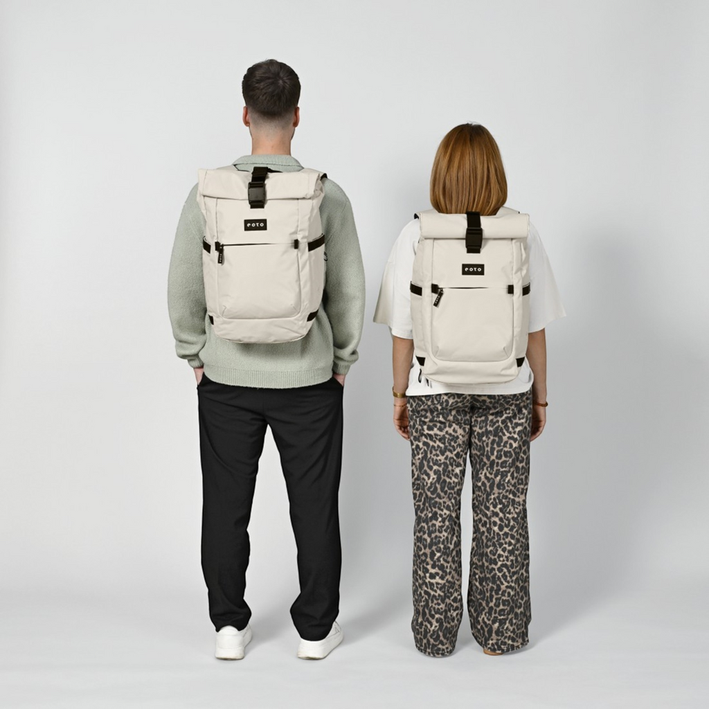 Lieblingstasche Rolly32 beige rolltop backpack worn by a man and a woman, showing the back view and adjustable straps.
