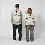 Lieblingstasche Rolly32 beige rolltop backpack worn by a man and a woman, showing the back view and adjustable straps.