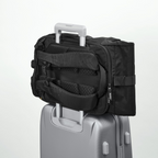 Lieblingstasche Rolly32 black rolltop backpack attached to a silver suitcase trolley handle for travel