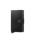Lieblingstasche Secrid Miniwallet in black leather with a snap button closure and integrated card protector mechanism.