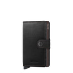 Lieblingstasche Secrid Miniwallet in black leather with a snap button closure and integrated card protector mechanism.