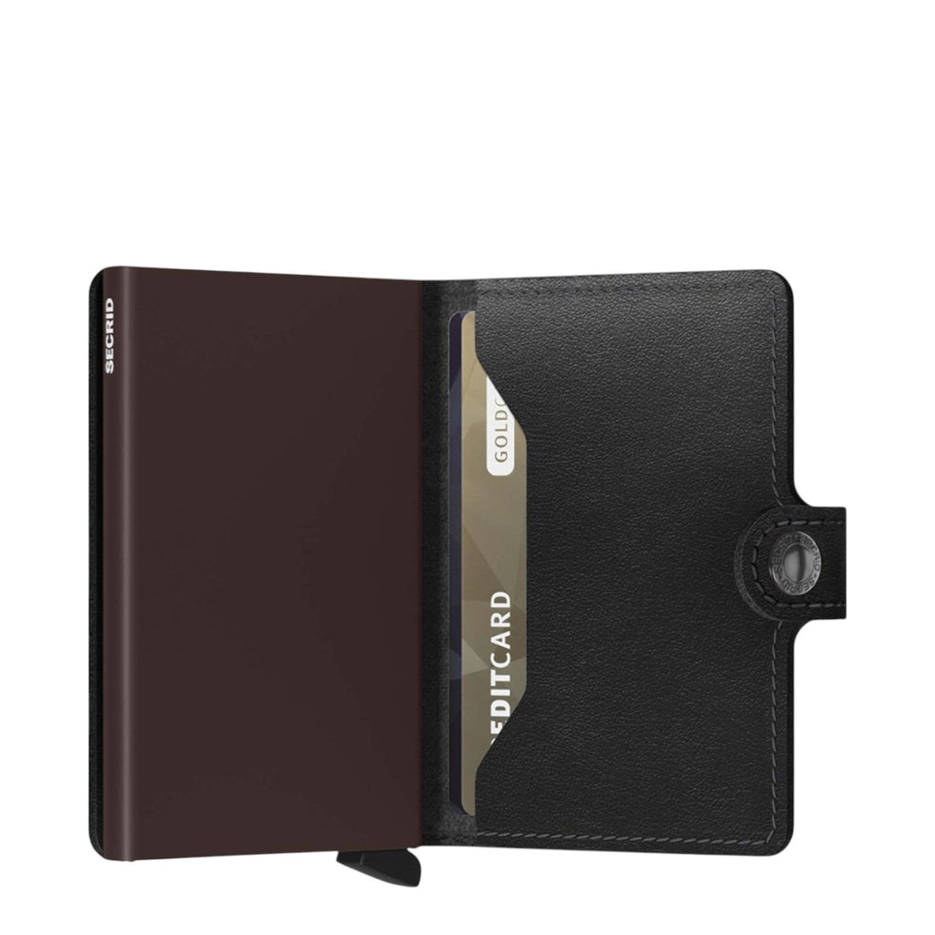Lieblingstasche Secrid Miniwallet in black leather with an integrated metal card protector and snap button closure.