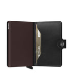 Lieblingstasche Secrid Miniwallet in black leather with an integrated metal card protector and snap button closure.