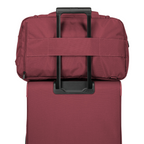 Lieblingstasche Skaii weekender bag in burgundy attached to a matching suitcase handle for easy travel.