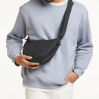 Lieblingstasche small black crossbody bag with adjustable strap, made of durable fabric.