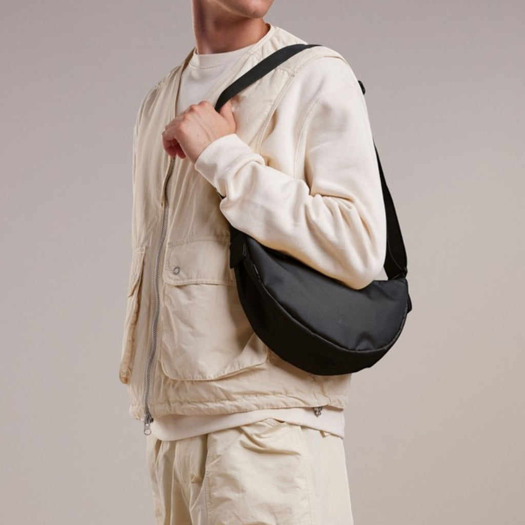 Lieblingstasche small black crescent-shaped crossbody bag made of nylon.