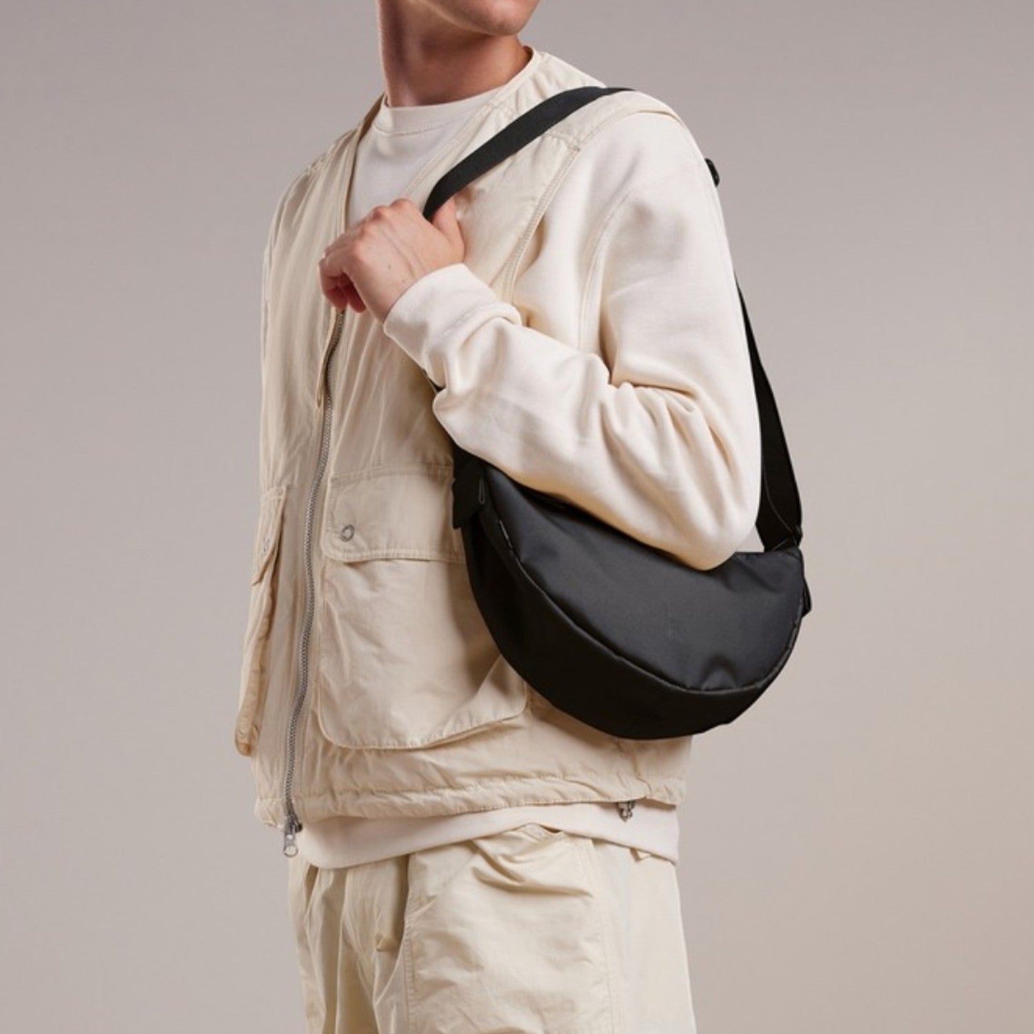 Lieblingstasche small black crescent-shaped crossbody bag made of nylon.