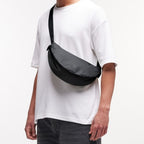 Lieblingstasche small dark grey crescent-shaped crossbody bag with adjustable strap.