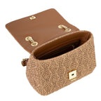 Lieblingstasche Ocarina flap bag in woven straw with brown leather interior and gold hardware.
