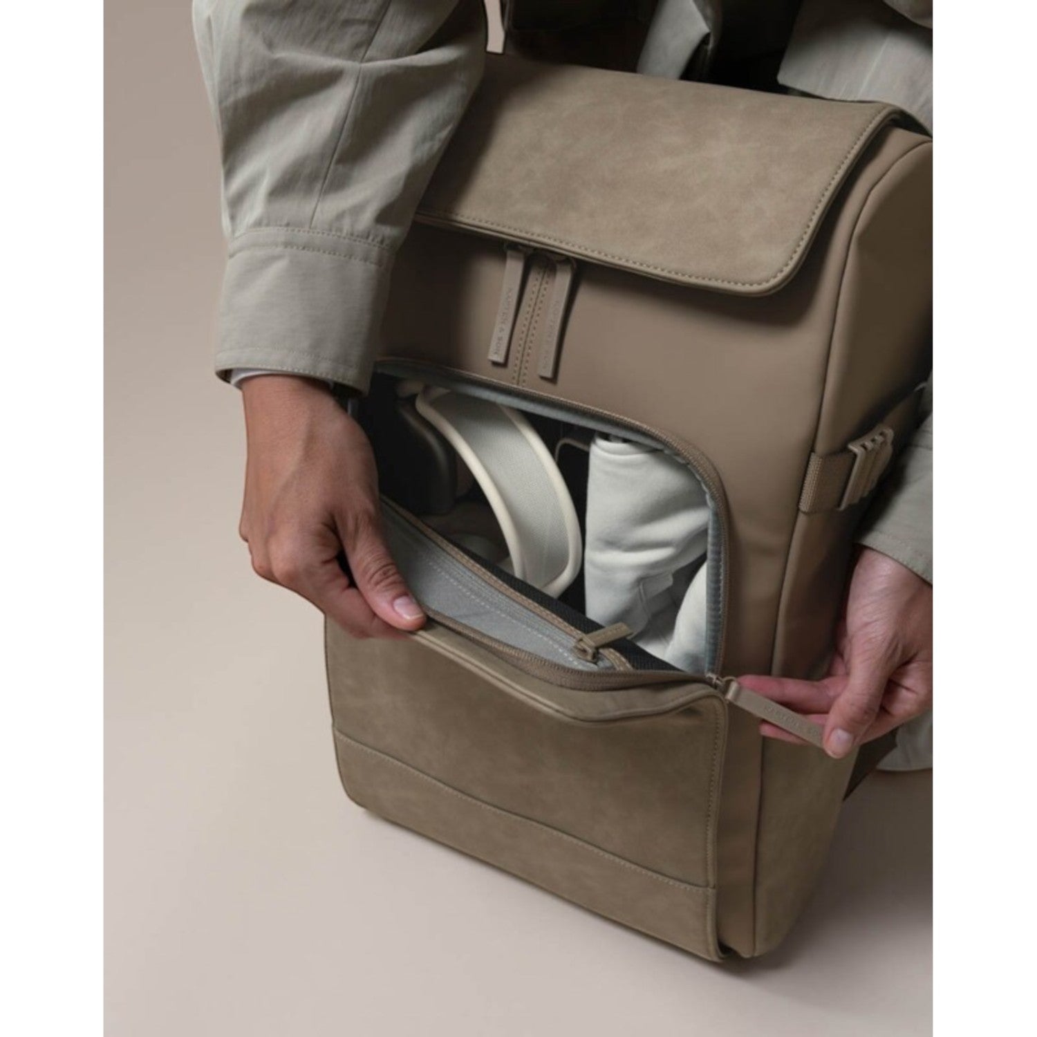 Lieblingstasche Bali Pro taupe faux leather backpack with front zip pocket and padded straps.