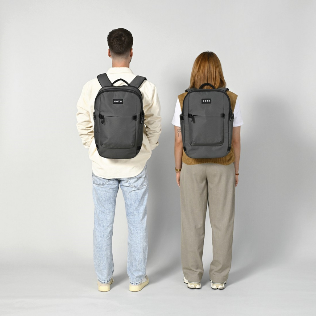 Lieblingstasche Tidy22 grey business laptop backpack worn by a man and woman against a neutral background