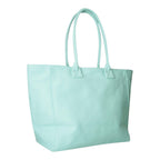 Lieblingstasche Tote L in mint green canvas with long shoulder straps, shown from a side angle.