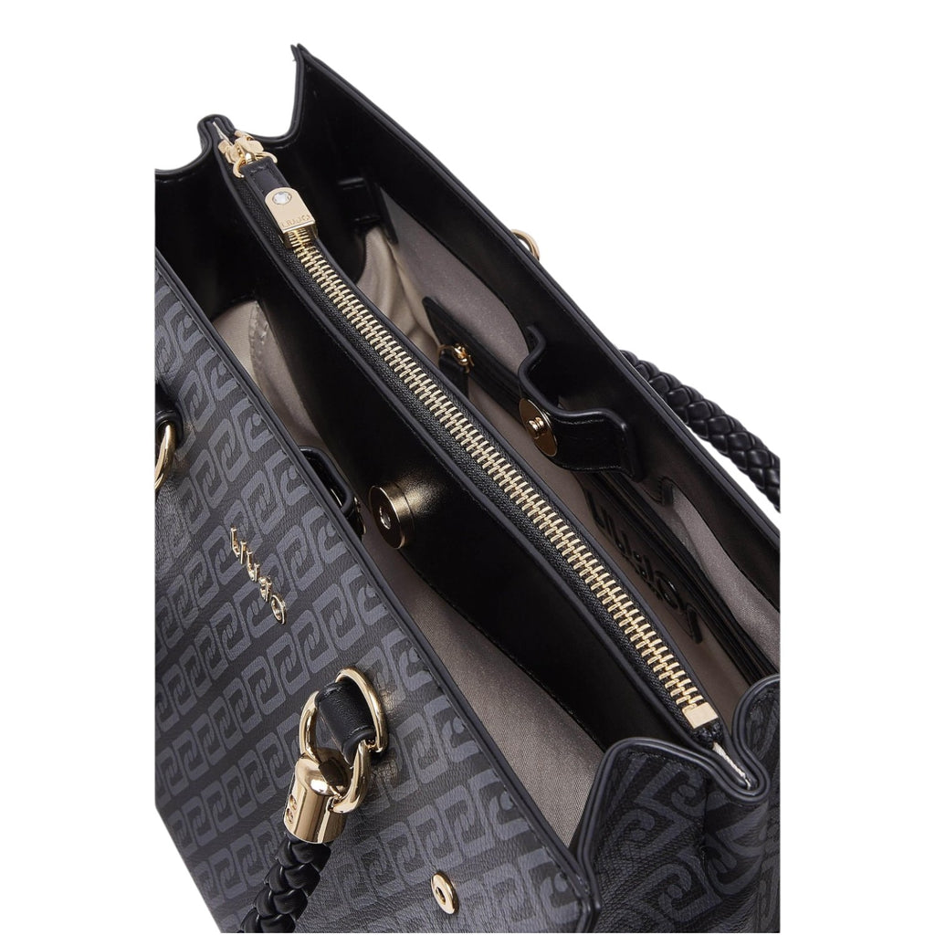 Lieblingstasche Tote M handbag interior with black patterned synthetic leather, gold zipper, and braided handles.