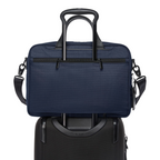 Lieblingstasche Tumi Alpha medium 15-inch navy blue briefcase attached to a black rolling suitcase handle