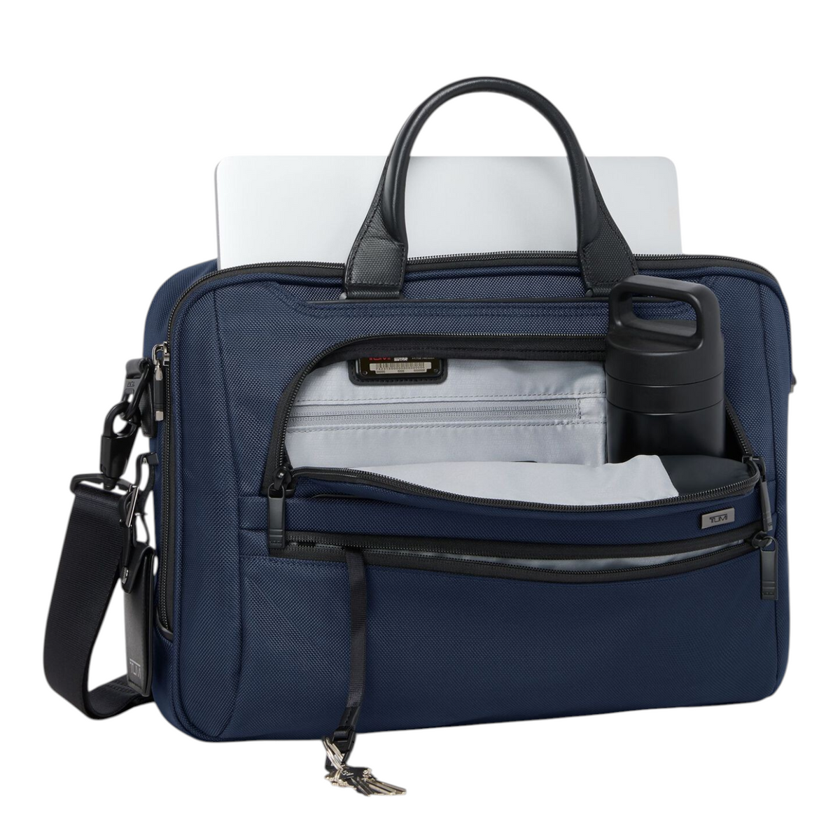 Lieblingstasche Tumi Alpha navy blue 15-inch expandable briefcase with laptop and water bottle in open front pocket