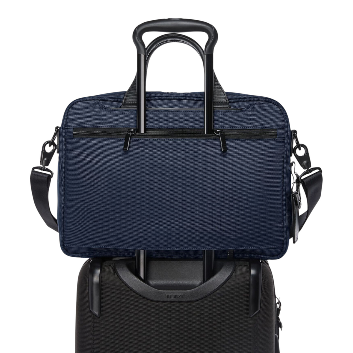 Lieblingstasche Tumi Alpha navy blue medium 15-inch expandable briefcase mounted on a black rolling suitcase handle