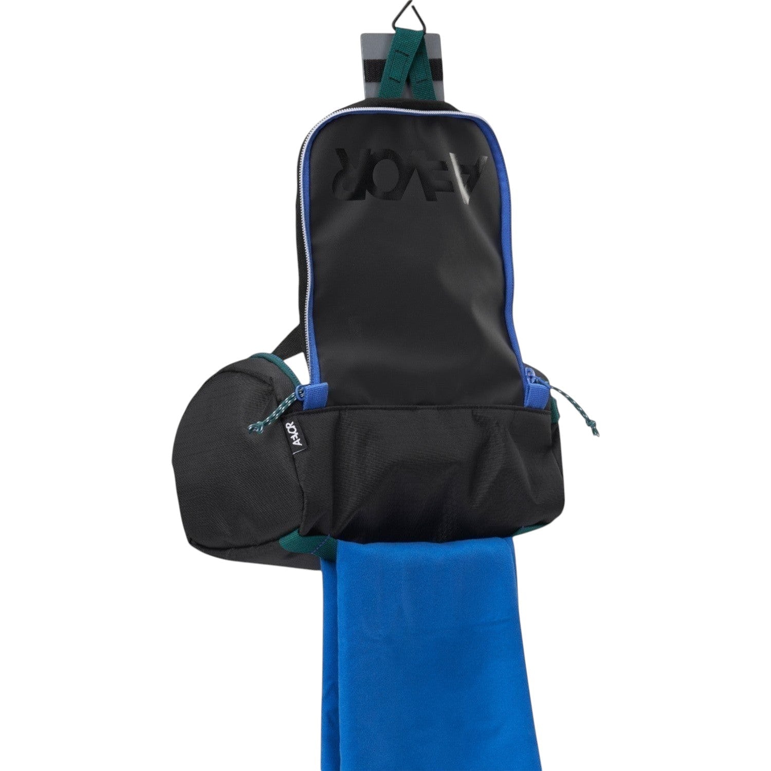 Lieblingstasche Wash Pack in black with blue accents, featuring a hanging design and a bright blue towel attached.